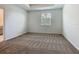 Bedroom featuring neutral carpet, tray ceiling, and a view into the bathroom at 7685 Stone Creek Trl, Kissimmee, FL 34747