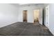 Bedroom featuring neutral carpet with walk-in closet and view into the bathroom at 7685 Stone Creek Trl, Kissimmee, FL 34747