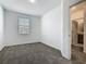 Bedroom featuring neutral carpet and a view into the bathroom at 7685 Stone Creek Trl, Kissimmee, FL 34747