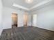 Bedroom featuring neutral carpet with walk-in closet and view into the bathroom at 7685 Stone Creek Trl, Kissimmee, FL 34747