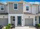 Inviting townhome with a charming entrance and well-kept landscaping, perfect for modern living at 7685 Stone Creek Trl, Kissimmee, FL 34747