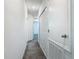 Hallway featuring neutral carpet, closet space and access to multiple rooms at 7685 Stone Creek Trl, Kissimmee, FL 34747