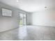 Bright living area featuring tile flooring, natural light, and sliding glass door to outdoor space at 7685 Stone Creek Trl, Kissimmee, FL 34747