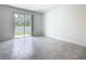 Bright living room with large sliding glass doors leading to outdoor area and neutral tile flooring at 7685 Stone Creek Trl, Kissimmee, FL 34747