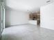 Open living room and kitchen space featuring neutral ceramic tile and modern recessed lighting at 7685 Stone Creek Trl, Kissimmee, FL 34747