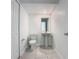 Compact powder room featuring a pedestal sink, tiled floors, and fresh, white paint at 7685 Stone Creek Trl, Kissimmee, FL 34747
