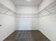 Spacious walk-in closet featuring gray carpet and wire shelving at 7685 Stone Creek Trl, Kissimmee, FL 34747