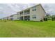 Back of the building displays spacious lawn with outdoor screened patios at 783 Ocean Course Ave, Davenport, FL 33896