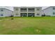 Exterior showcases a well-maintained lawn and building with screened patios at 783 Ocean Course Ave, Davenport, FL 33896