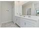 Bathroom with double sink, granite countertops, vanity, and a large mirror at 783 Ocean Course Ave, Davenport, FL 33896