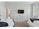 Bright bedroom with closet, TV and minimalist decor at 783 Ocean Course Ave, Davenport, FL 33896