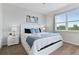 Well-lit bedroom with a comfortable bed, two nightstands, and a large window at 783 Ocean Course Ave, Davenport, FL 33896