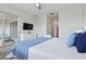 Bedroom with a large bed, sliding door access to a balcony, and dresser with TV at 783 Ocean Course Ave, Davenport, FL 33896