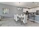 Dining area adjacent to kitchen with modern white table, seating for six and an open concept at 783 Ocean Course Ave, Davenport, FL 33896