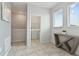 Hallway with tile floors leads to a laundry room with a modern console table at 783 Ocean Course Ave, Davenport, FL 33896