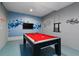 A modern entertainment room with a pool table and unique decor accents on the walls at 783 Ocean Course Ave, Davenport, FL 33896
