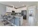 Modern kitchen island featuring gray countertops, pendant lighting, with stainless steel appliances at 783 Ocean Course Ave, Davenport, FL 33896