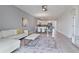 Open-concept living room with a modern white sectional couch, dining area and kitchen at 783 Ocean Course Ave, Davenport, FL 33896