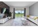 Bright living room with tile flooring, modern furniture, and access to a balcony with a view at 783 Ocean Course Ave, Davenport, FL 33896