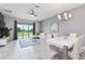 Modern living area with an open dining space, tile floors, and a sliding glass door leading to the outside at 783 Ocean Course Ave, Davenport, FL 33896