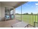 Relaxing screened patio with seating and view of bedroom offers serene views of the golf course at 783 Ocean Course Ave, Davenport, FL 33896