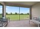 Relaxing screened patio with seating offers serene views of the lush green landscape at 783 Ocean Course Ave, Davenport, FL 33896