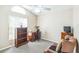 Bedroom featuring neutral walls, carpet, built in shelves, desk and comfortable arm chair at 7922 Elmstone Cir, Orlando, FL 32822