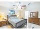 Bedroom with ceiling fan, bed, and lamps at 7922 Elmstone Cir, Orlando, FL 32822