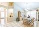 Formal dining room with a chandelier, large windows, tile floors, and seating for six at 7922 Elmstone Cir, Orlando, FL 32822