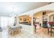 Open concept dining room view with tile floors, chandelier, and views of the living room at 7922 Elmstone Cir, Orlando, FL 32822