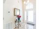 Welcoming entryway with tile floors, a decorative table with flowers, and natural light at 7922 Elmstone Cir, Orlando, FL 32822