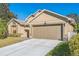 Two-car garage, meticulously maintained lawn, and attractive landscaping create curb appeal at 7922 Elmstone Cir, Orlando, FL 32822