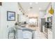 Kitchen offers stainless steel appliances, white cabinets, granite countertops, tile floors, and a breakfast bar at 7922 Elmstone Cir, Orlando, FL 32822