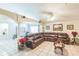 Open-concept living room with sectional sofa, tile flooring, and decorative columns at 7922 Elmstone Cir, Orlando, FL 32822