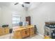 Well-lit office with neutral walls, large desk, and modern computer setup at 7922 Elmstone Cir, Orlando, FL 32822