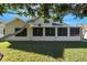 Enclosed sunroom featuring multiple windows that offer ample natural light and backyard view at 7922 Elmstone Cir, Orlando, FL 32822