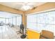 Bright sunroom with tile flooring, large windows, and open access to other living spaces at 7922 Elmstone Cir, Orlando, FL 32822