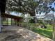 Spacious backyard with covered deck and large tree at 793 N Kentucky Ave, Umatilla, FL 32784