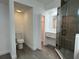 Bright bathroom with modern vanity, toilet, walk-in shower and closet at 793 N Kentucky Ave, Umatilla, FL 32784