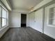 Bright bedroom with gray flooring, fresh white walls, and a large window for natural light at 793 N Kentucky Ave, Umatilla, FL 32784