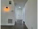 Hallway with sleek gray floors and a lighted wall fixture at 793 N Kentucky Ave, Umatilla, FL 32784