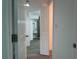 Hallway featuring white doors, and a view of the renovated bathroom with modern vanity at 793 N Kentucky Ave, Umatilla, FL 32784