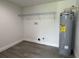 Utility Room with gray water heater, shelving, and sleek gray floors at 793 N Kentucky Ave, Umatilla, FL 32784