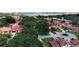 An aerial view shows many houses with red roofs and trees, plus a view of the lake from a distance at 8057 Marcella Dr, Orlando, FL 32836