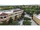 A multi-story commercial building has off-street parking and is surrounded by trees at 8057 Marcella Dr, Orlando, FL 32836