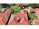 Aerial view of a red tile roof home with green grass, a white truck, and dark cars in the neighborhood at 8057 Marcella Dr, Orlando, FL 32836