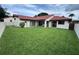 Expansive backyard with lush green grass, featuring a covered patio for outdoor living at 8057 Marcella Dr, Orlando, FL 32836