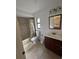 Bathroom with shower-tub combo, toilet, vanity with mirror and fixtures, and tile floors at 8057 Marcella Dr, Orlando, FL 32836