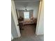 Cozy bedroom featuring carpet, a ceiling fan, natural light, and a desk for work or study at 8057 Marcella Dr, Orlando, FL 32836