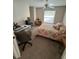 Bedroom with carpet flooring, ceiling fan, natural light, and a dedicated desk area at 8057 Marcella Dr, Orlando, FL 32836